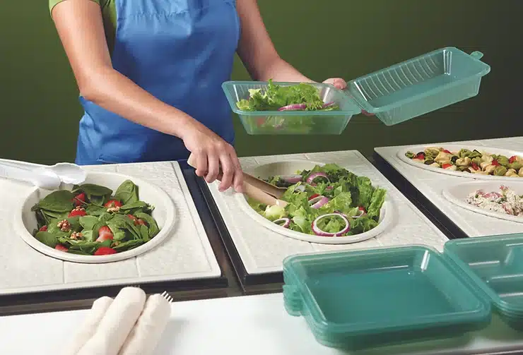serving salad into eco-takeouts containers